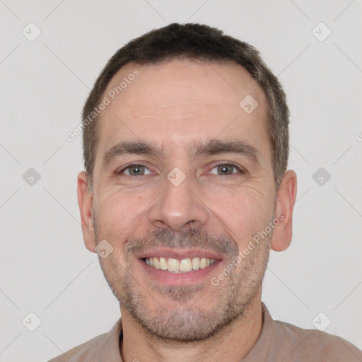 Joyful white adult male with short  brown hair and brown eyes