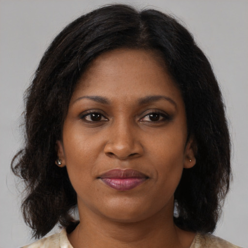 Joyful black young-adult female with medium  brown hair and brown eyes