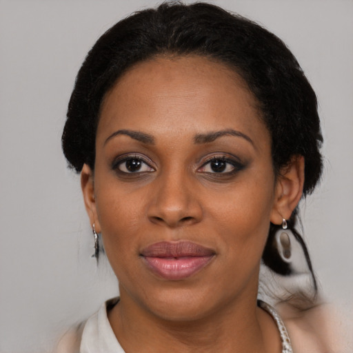 Joyful black adult female with medium  black hair and brown eyes