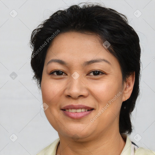 Joyful asian adult female with medium  brown hair and brown eyes