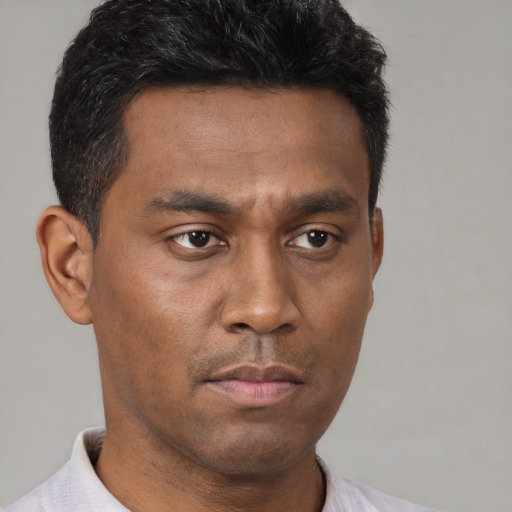 Neutral latino young-adult male with short  brown hair and brown eyes
