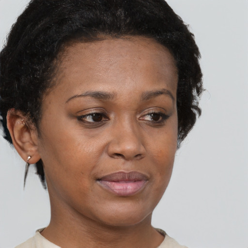 Joyful black young-adult female with short  brown hair and brown eyes