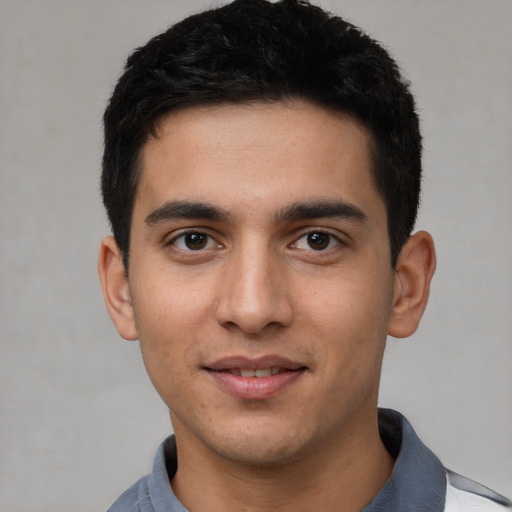 Joyful white young-adult male with short  black hair and brown eyes