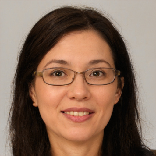 Joyful white adult female with long  brown hair and brown eyes