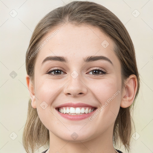 Joyful white young-adult female with medium  brown hair and blue eyes