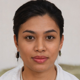 Joyful latino young-adult female with short  brown hair and brown eyes