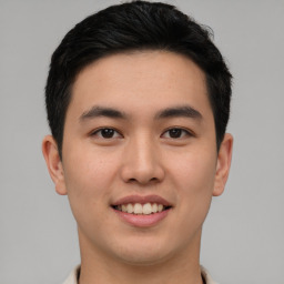 Joyful asian young-adult male with short  black hair and brown eyes