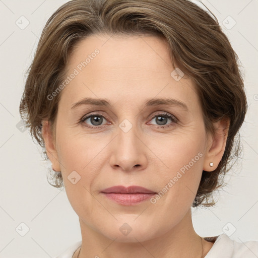 Joyful white adult female with medium  brown hair and grey eyes