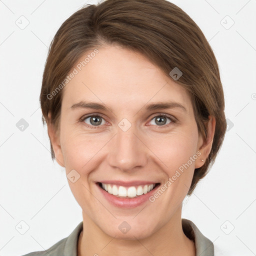 Joyful white young-adult female with short  brown hair and grey eyes