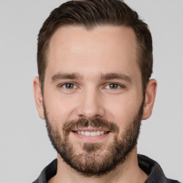 Joyful white young-adult male with short  brown hair and brown eyes