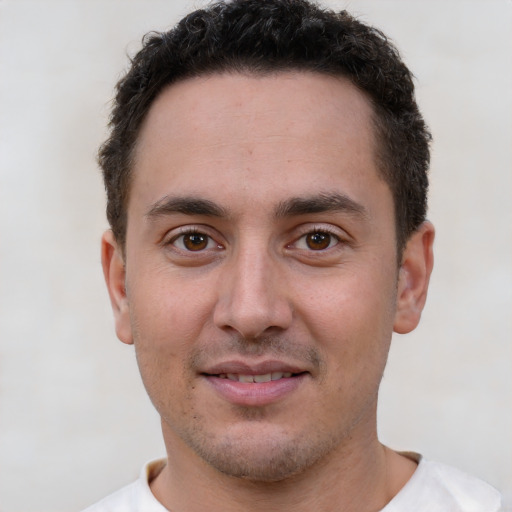 Joyful white young-adult male with short  brown hair and brown eyes