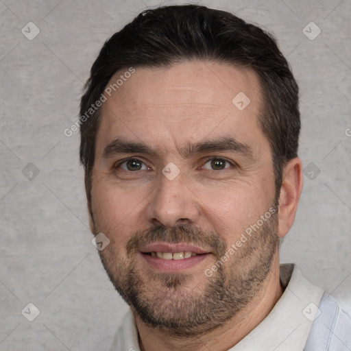 Joyful white adult male with short  brown hair and brown eyes