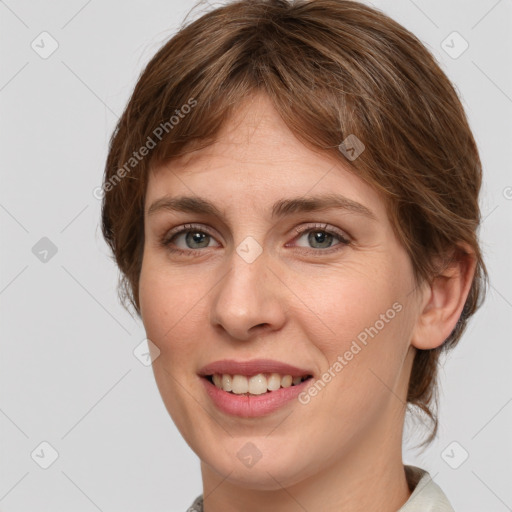 Joyful white young-adult female with medium  brown hair and grey eyes