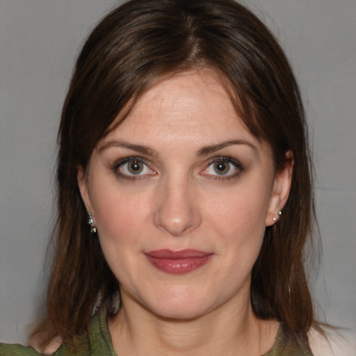 Joyful white young-adult female with medium  brown hair and green eyes