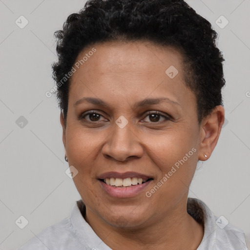 Joyful latino adult female with short  brown hair and brown eyes