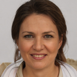 Joyful white adult female with medium  brown hair and brown eyes