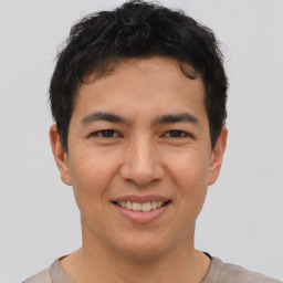 Joyful asian young-adult male with short  brown hair and brown eyes