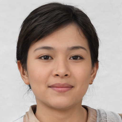 Joyful asian young-adult female with short  brown hair and brown eyes