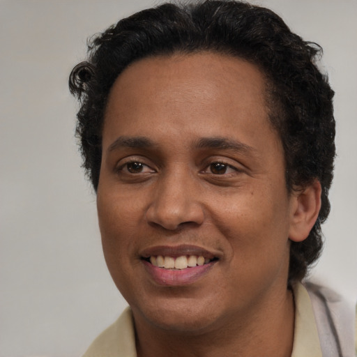 Joyful latino adult male with short  black hair and brown eyes