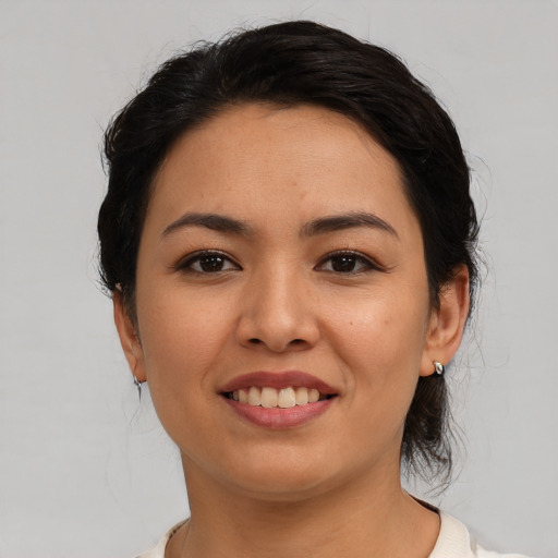 Joyful asian young-adult female with medium  black hair and brown eyes