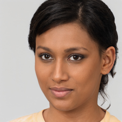 Joyful latino young-adult female with short  brown hair and brown eyes