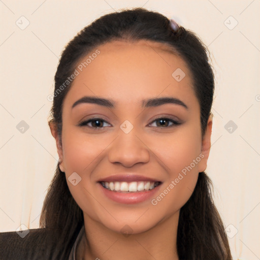 Joyful latino young-adult female with long  black hair and brown eyes