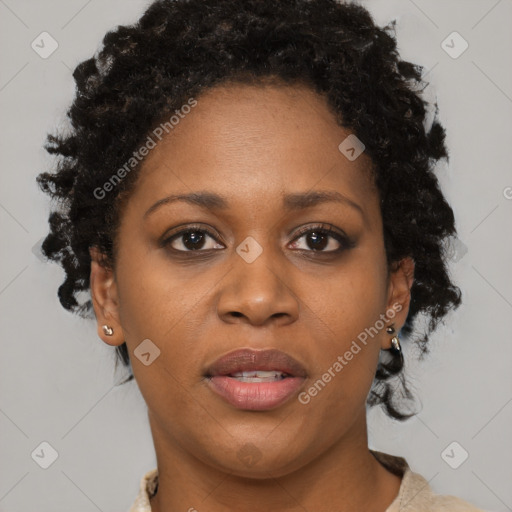 Joyful black adult female with short  brown hair and brown eyes