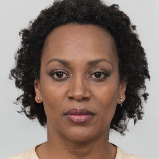 Joyful black adult female with short  brown hair and brown eyes