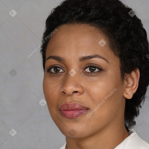 Joyful black young-adult female with short  black hair and brown eyes