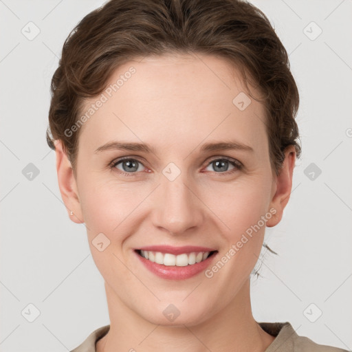 Joyful white young-adult female with short  brown hair and grey eyes