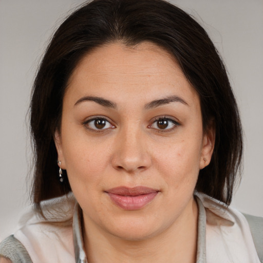 Joyful latino young-adult female with medium  brown hair and brown eyes