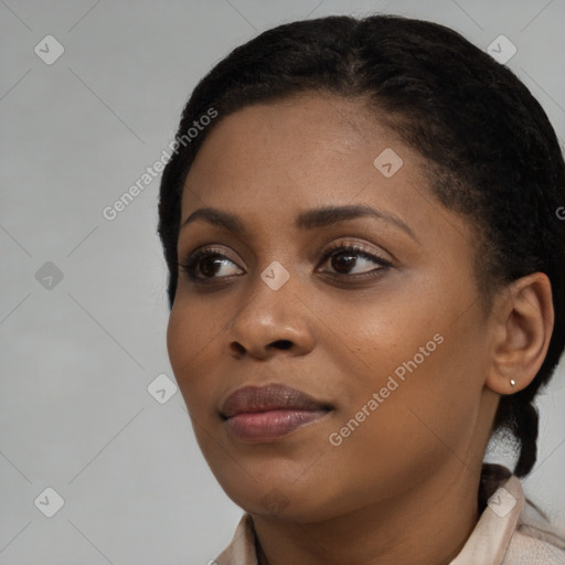 Joyful black young-adult female with long  black hair and brown eyes