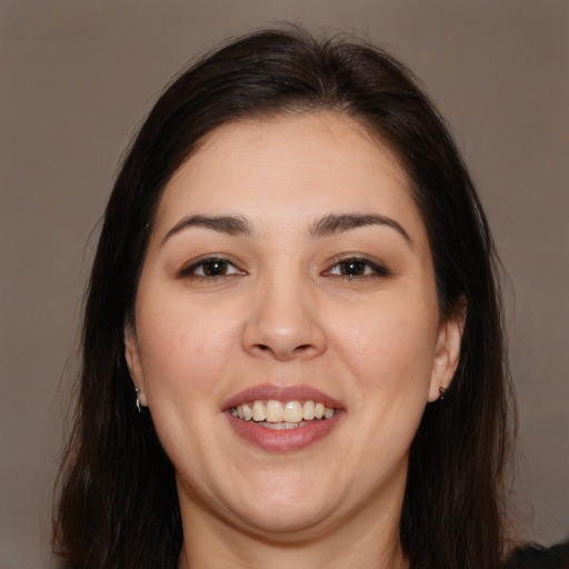 Joyful white young-adult female with long  brown hair and brown eyes