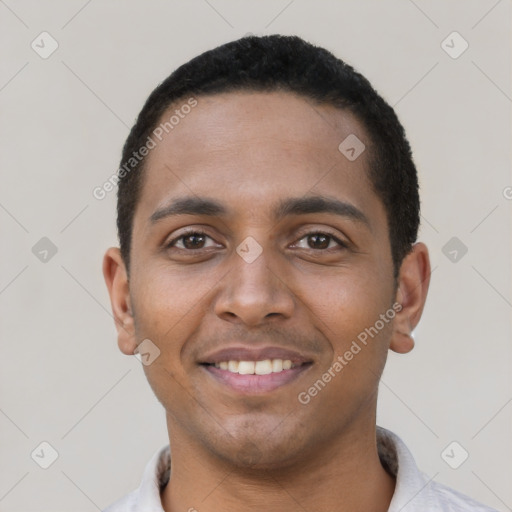 Joyful black young-adult male with short  black hair and brown eyes