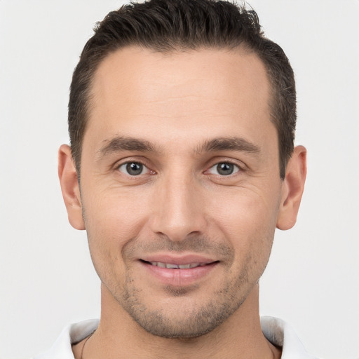 Joyful white young-adult male with short  brown hair and brown eyes