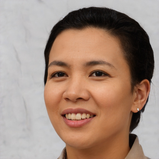 Joyful asian young-adult female with short  black hair and brown eyes