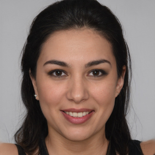 Joyful white young-adult female with long  brown hair and brown eyes