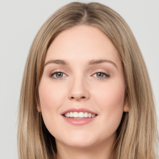 Joyful white young-adult female with long  brown hair and grey eyes