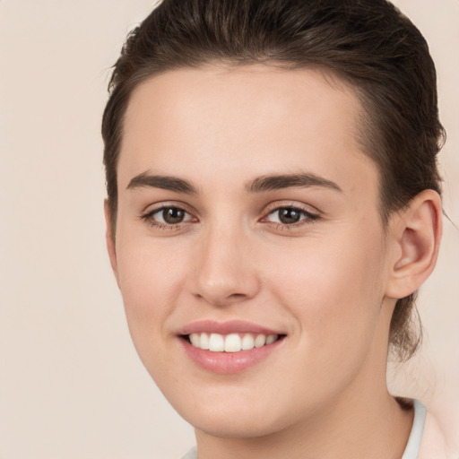 Joyful white young-adult female with short  brown hair and brown eyes