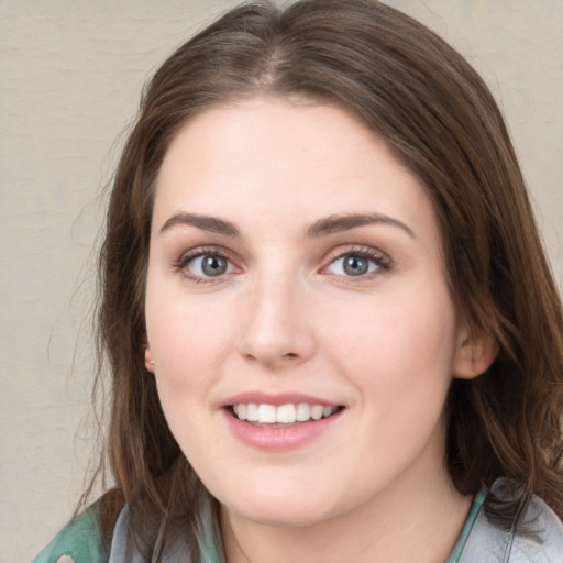 Joyful white young-adult female with medium  brown hair and green eyes