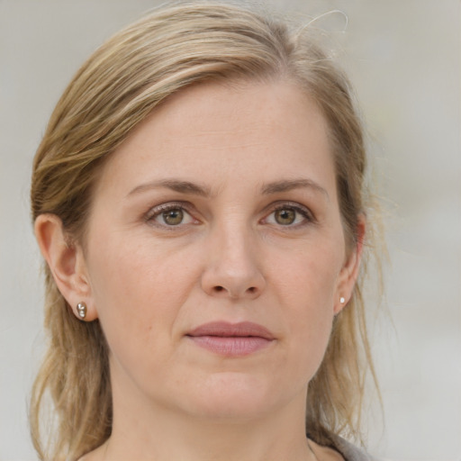 Joyful white adult female with medium  brown hair and grey eyes