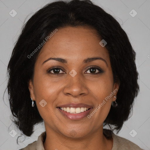 Joyful black adult female with medium  brown hair and brown eyes