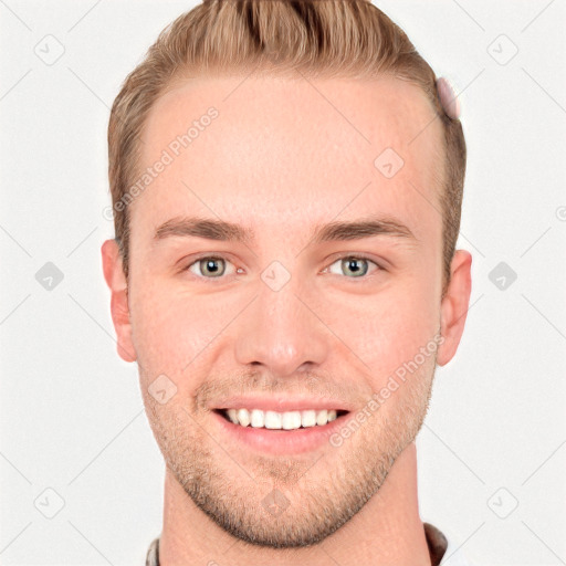 Joyful white young-adult male with short  brown hair and grey eyes