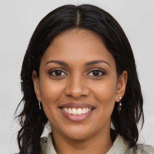 Joyful black young-adult female with medium  black hair and brown eyes