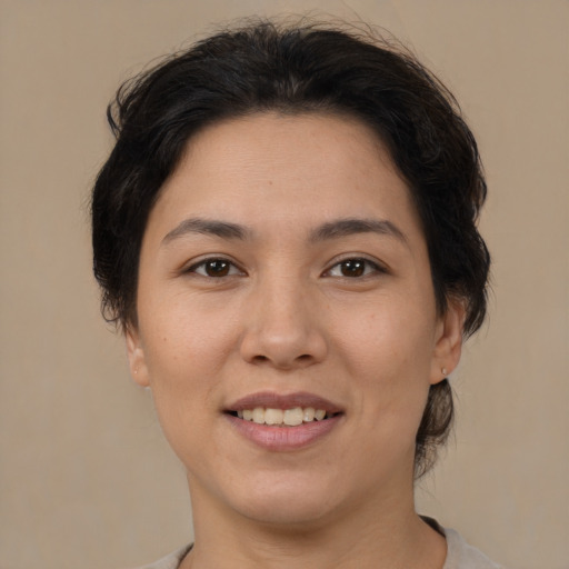 Joyful latino young-adult female with short  brown hair and brown eyes