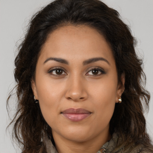 Joyful latino young-adult female with long  brown hair and brown eyes