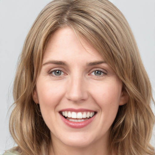 Joyful white young-adult female with medium  brown hair and green eyes