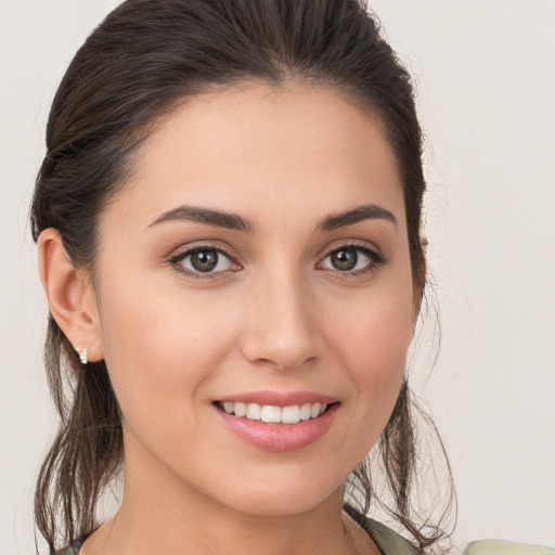 Joyful white young-adult female with medium  brown hair and brown eyes