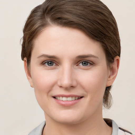 Joyful white young-adult female with short  brown hair and grey eyes