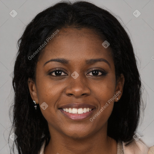 Joyful black young-adult female with long  brown hair and brown eyes